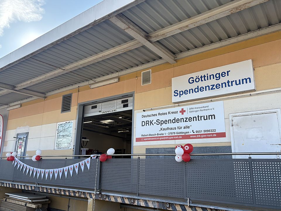 2026_03_03_Spendenzentrum_von_außen_Einweihung.jpg Außenansicht des neuen DRK‑Spendenzentrums Göttingen in der Robert‑Bosch‑Breite. Das Gebäude ist mit roten und weißen DRK‑Luftballons und Wimpeln für die Einweihungsfeier geschmückt