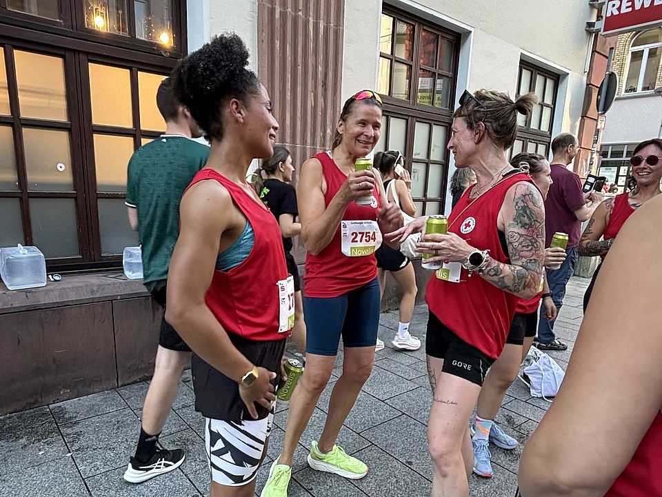 2026_07_01_Altstadt-Läuferinnen.jpeg DRK‑Läufer*innen beim Altstadtlauf Göttingen 2026 im Austausch am Streckenrand nach dem Lauf